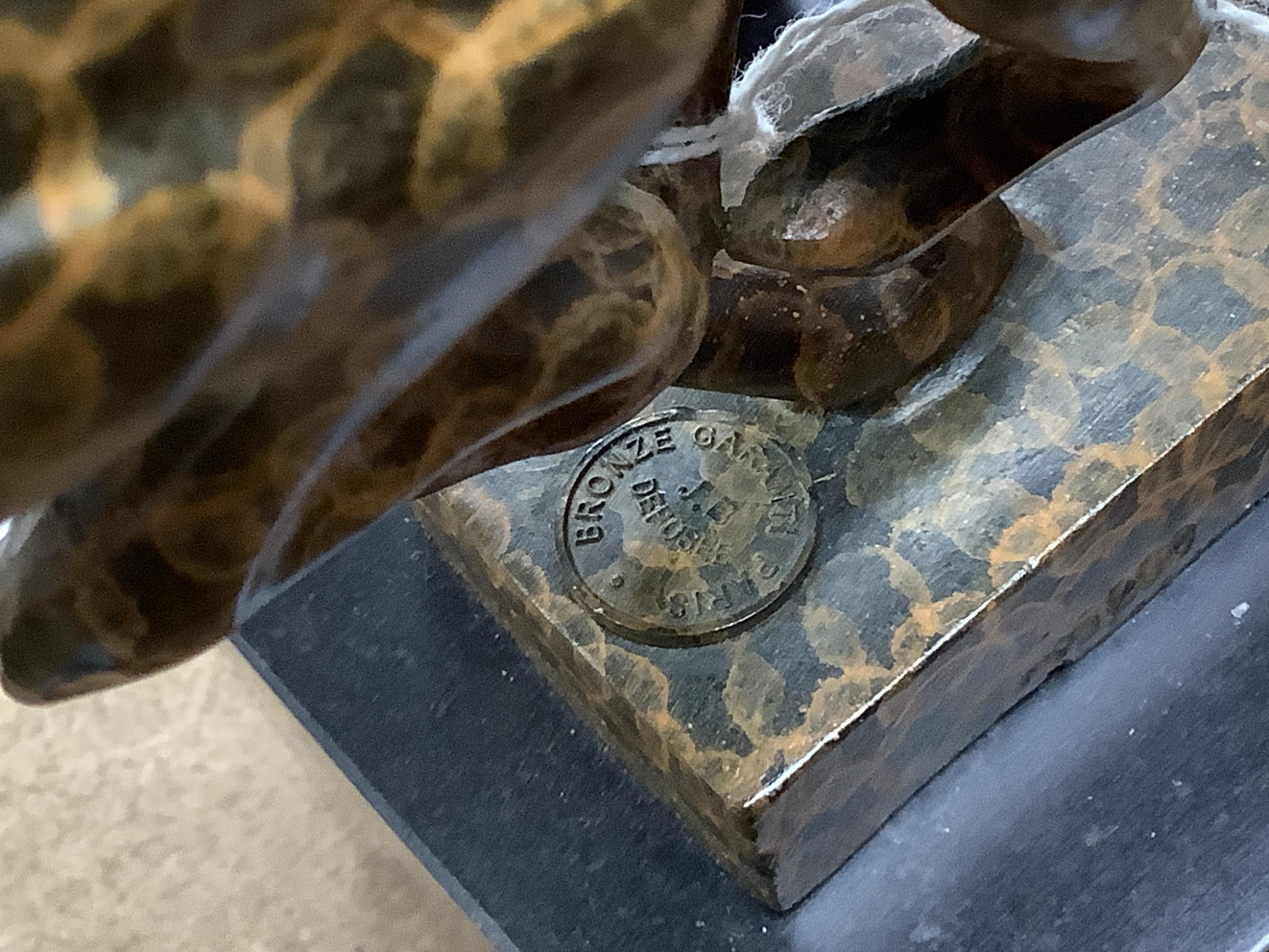 A patinated bronze cheetah bearing J.B. Depose foundry stamp, on slate plinth, 19cm high